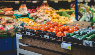 a picture of a store of food including vegetables and fruits 